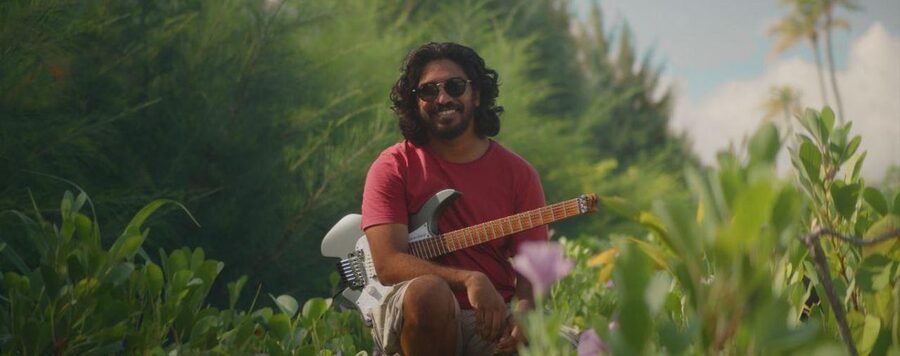 In a garden with a white guitar