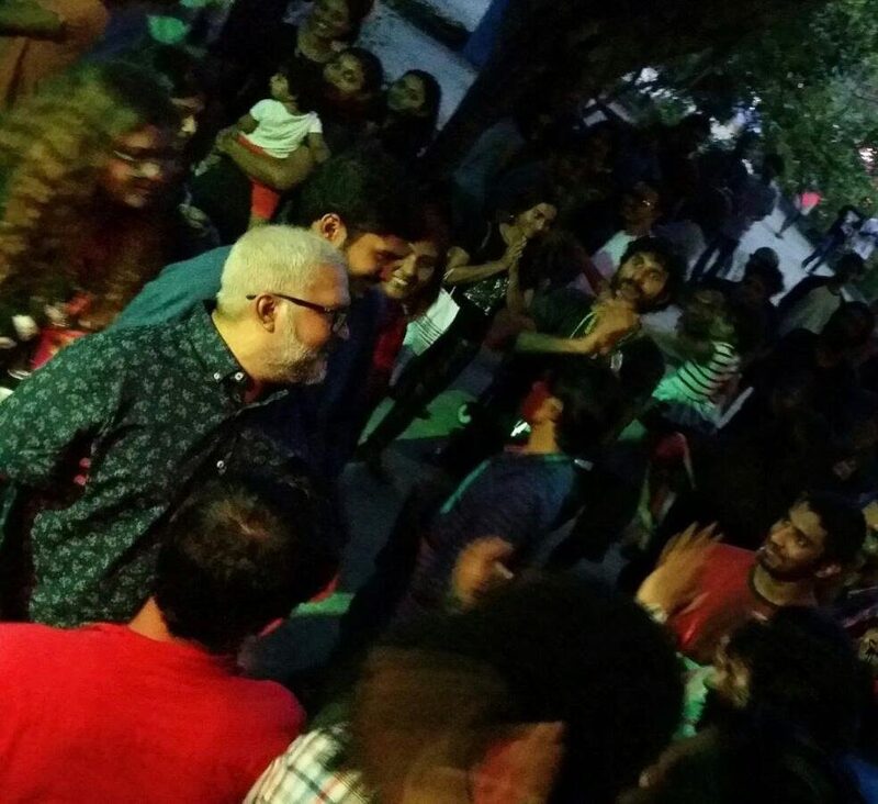 A crowd gathered close at night