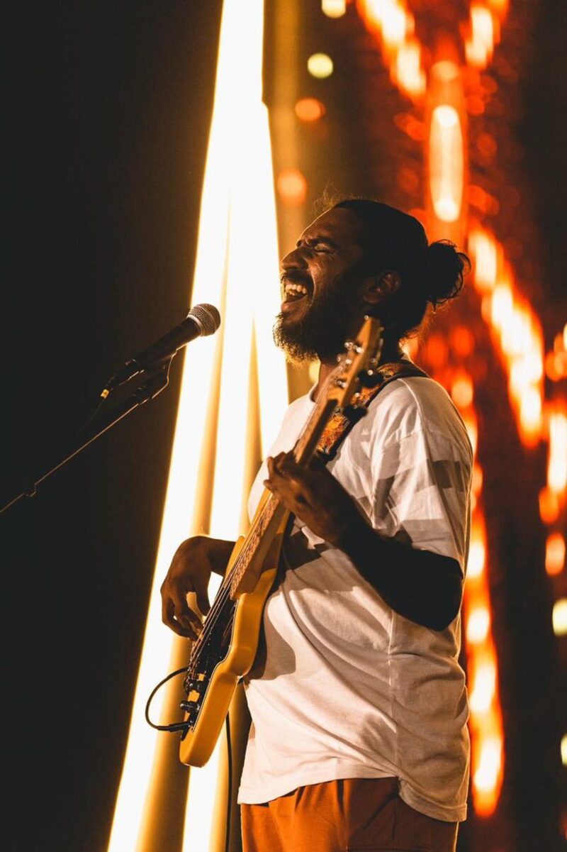 Singing in front of a wall of lights