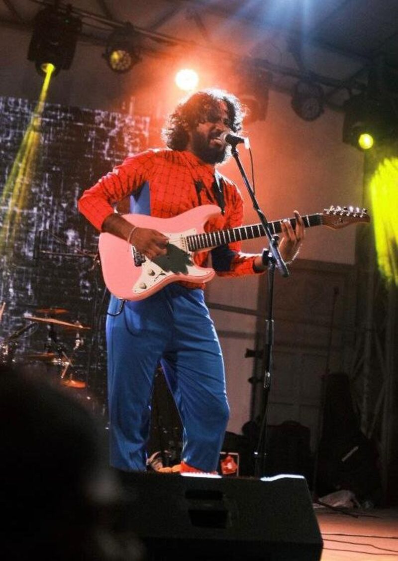 Red shirt, white guitar, halo of light