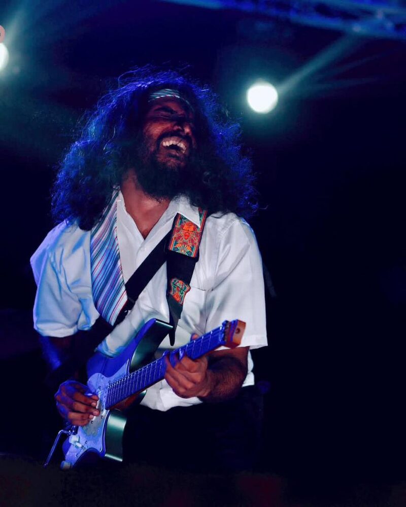 Head thrown back with a blue guitar
